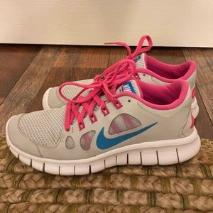 Gray and pink Nike running shoes